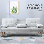 3 seater Gray sofa bed with wooden legs in a room with a framed picture on the wall.