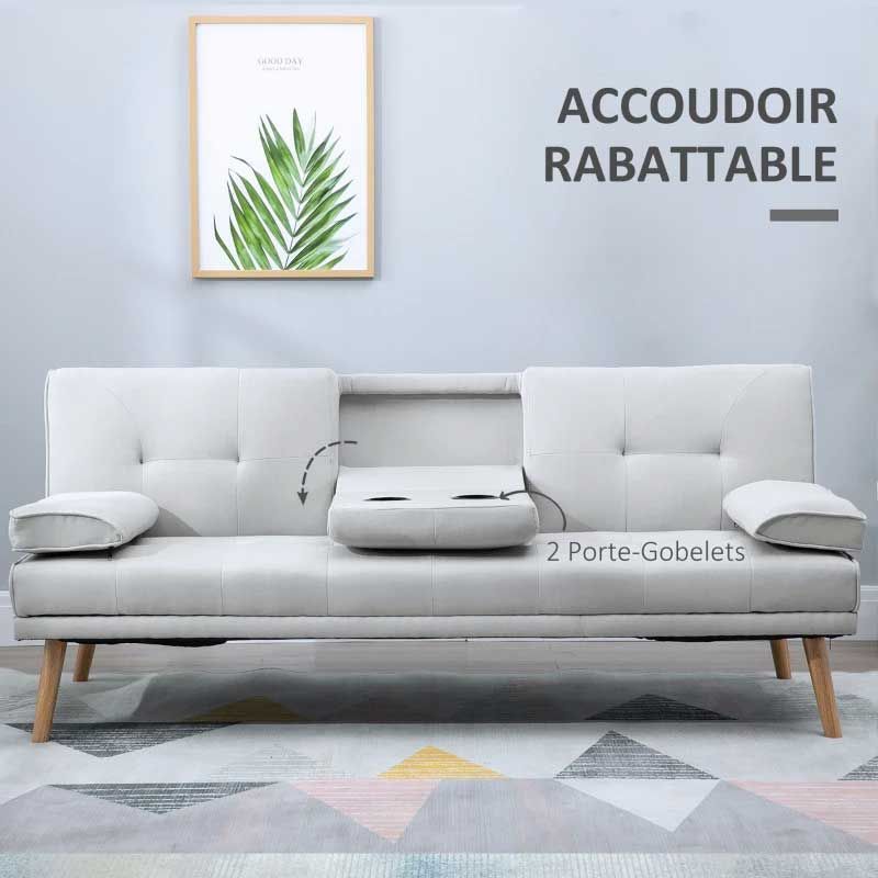 3 seater Gray sofa bed with wooden legs in a room with a framed picture on the wall.