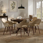 A 7-piece dining set featuring a dark wood oval table and six upholstered chairs in beige velvet and fabric, styled in a bright, modern dining room.