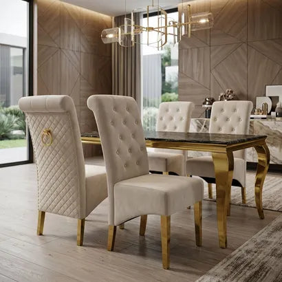 A luxury dining room set featuring four upholstered dining chairs with tufted backs and gold legs, paired with a rectangular table with a dark marble top and gold legs, set in a modern dining room with wood-paneled walls.
