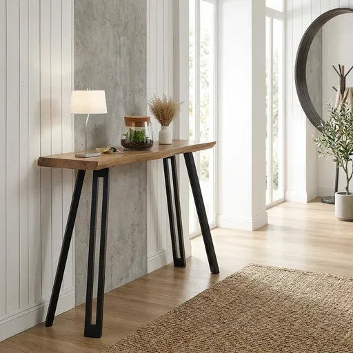 A modern console table with a light brown wood top and black metal A-frame legs,