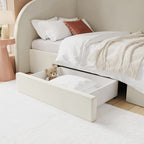 Bed with storage drawers and a teddy bear inside, in a bedroom setting.