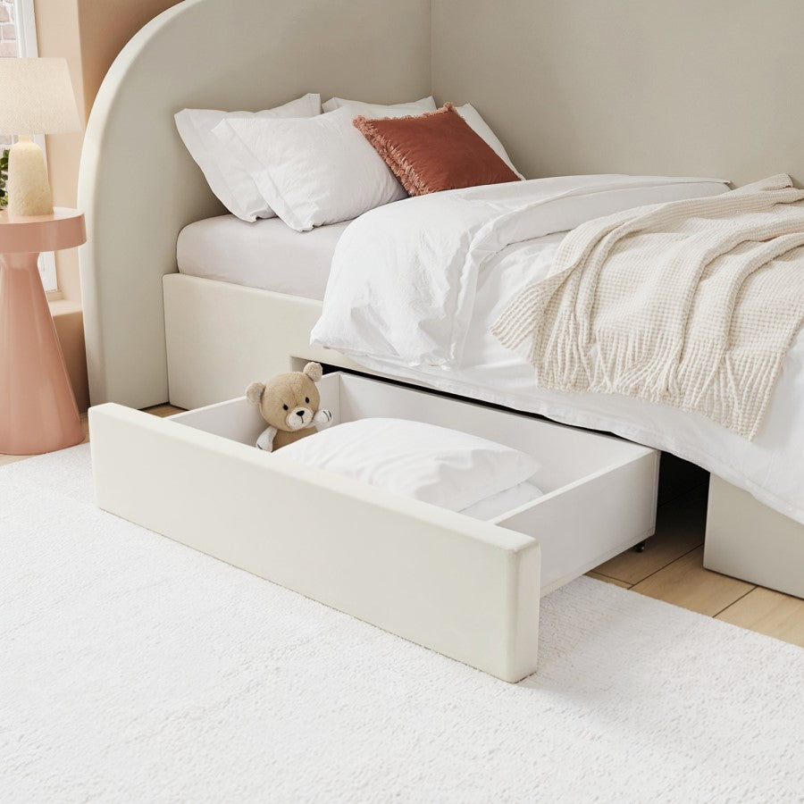 Bed with storage drawers and a teddy bear inside, in a bedroom setting.