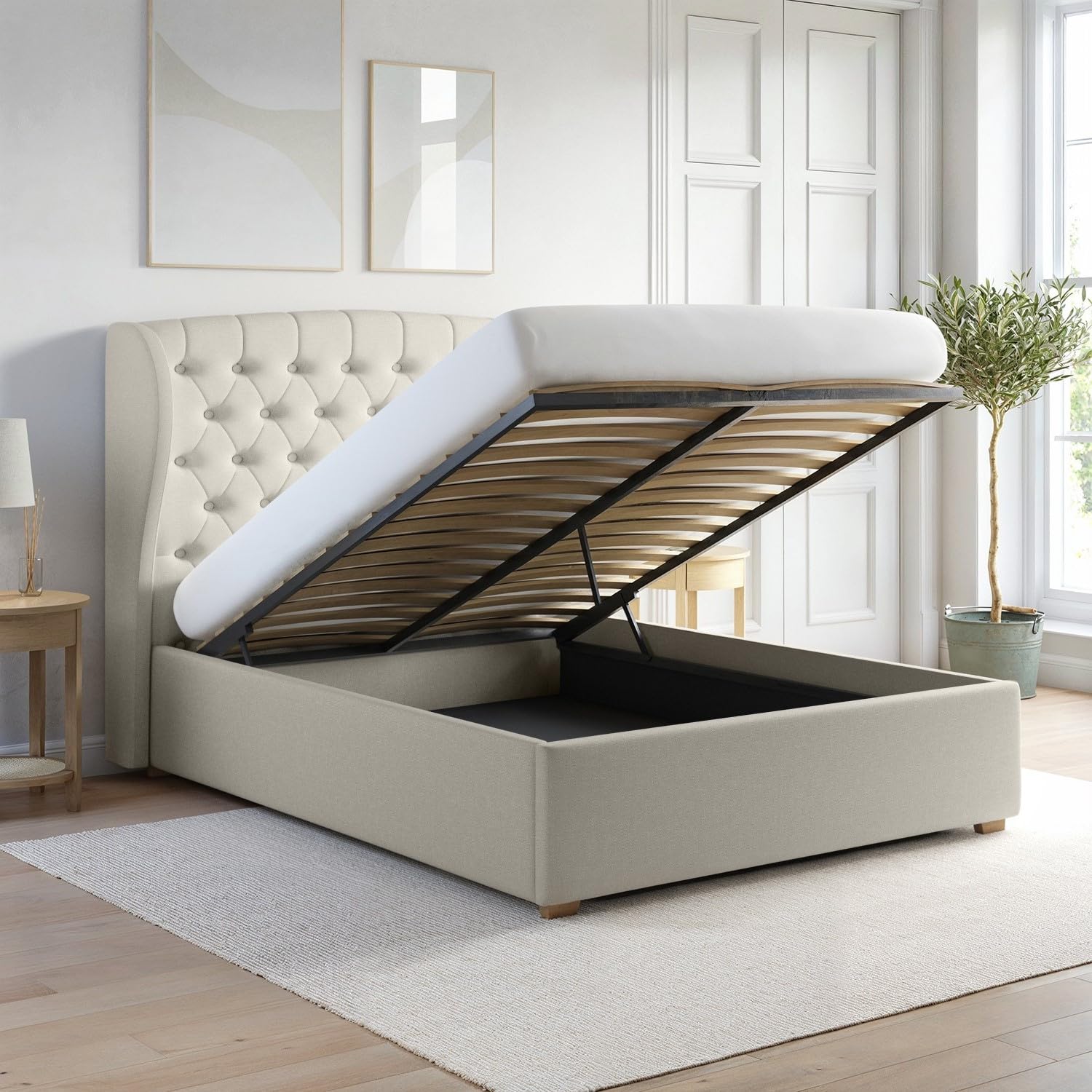 Beige upholstered bed with open storage compartment in a bright room.