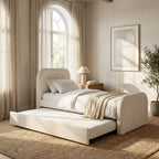 Beige upholstered bed with pull-out trundle in a bright bedroom.
