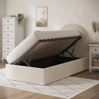 Beige upholstered bed with storage compartment in a room setting.
