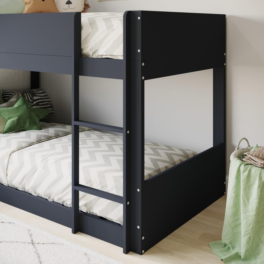 Black bunk bed with white bedding in a room setting