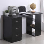 Black desk with laptop, books, and decorative items on a white floor.