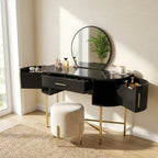 Black vanity table with round mirror and gold legs in a bright room.
