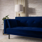 Blue sofa in a living room with a lamp and plant