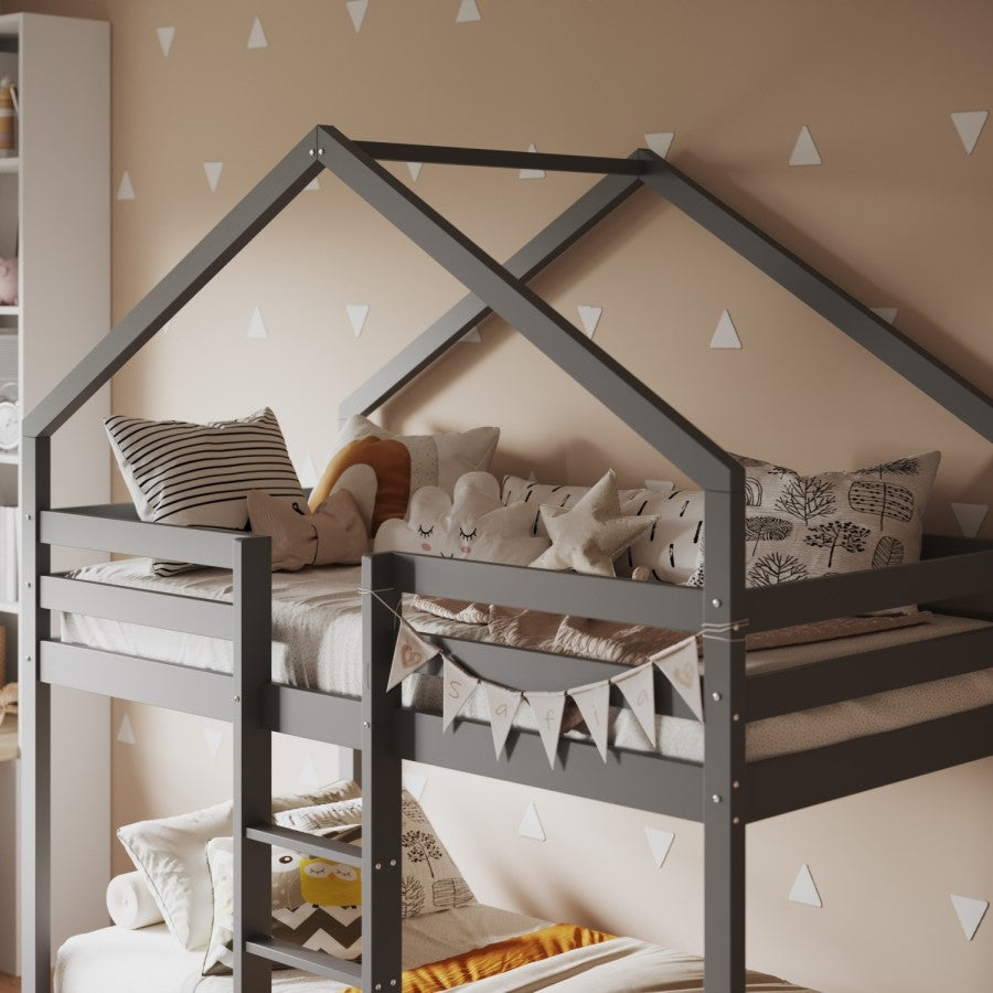 Children's room with a gray house-shaped bed, pillows, and a banner.