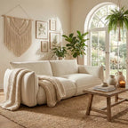 Cozy living room with a beige sofa, knitted blanket, and decorative elements.