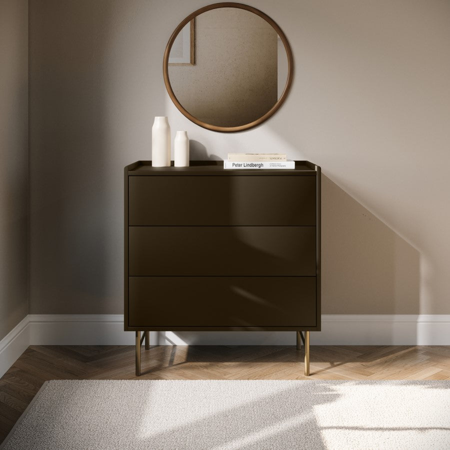 Dark brown dresser with three drawers in a room with a round mirror on the wall.