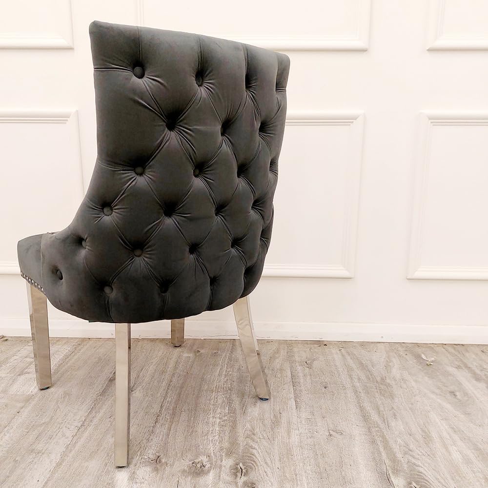 Dark gray tufted chair with chrome legs on a wooden floor.