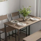 Dining table set with chairs and a vase of flowers in a room.