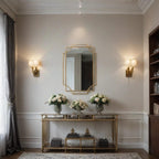 Elegant interior with a gold console table, mirror, and wall sconces.