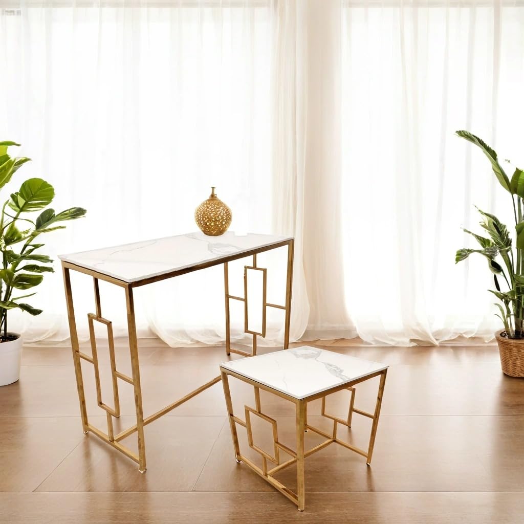 Gold-framed table and chair set with marble top in a room with plants and curtains.