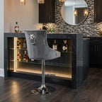 Gray bar stool with lion emblem in front of a bar counter with bottles and lighting.