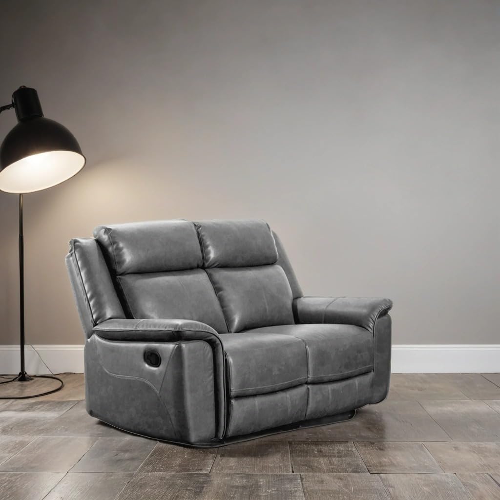 Gray recliner sofa in a room with a lamp and neutral walls.
