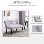 Gray retro-style loveseat with button-tufted details in a room setting.