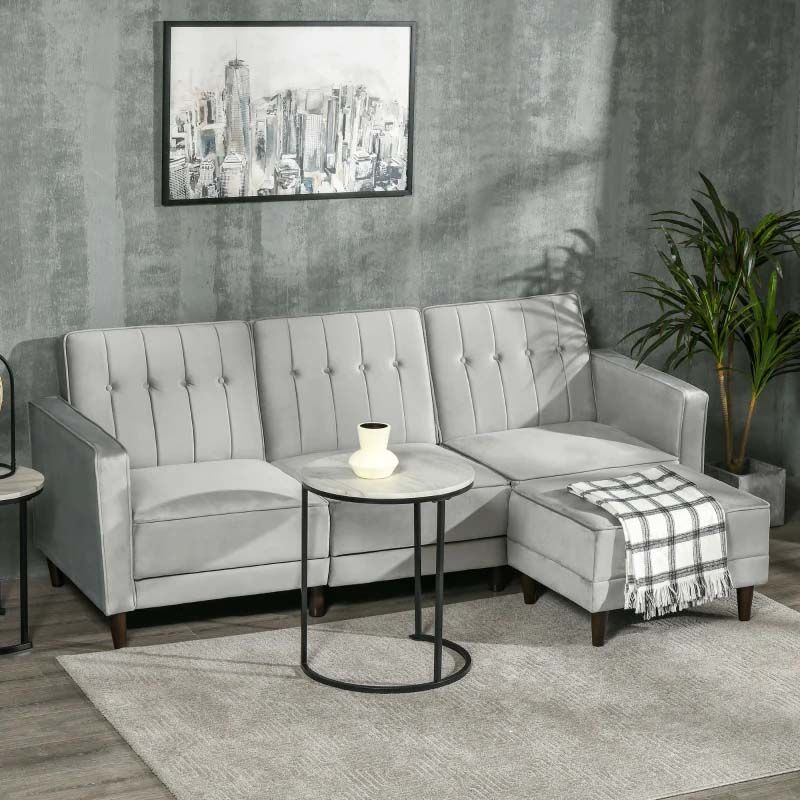 Gray sectional sofa in a living room setting with a cityscape painting on the wall.
