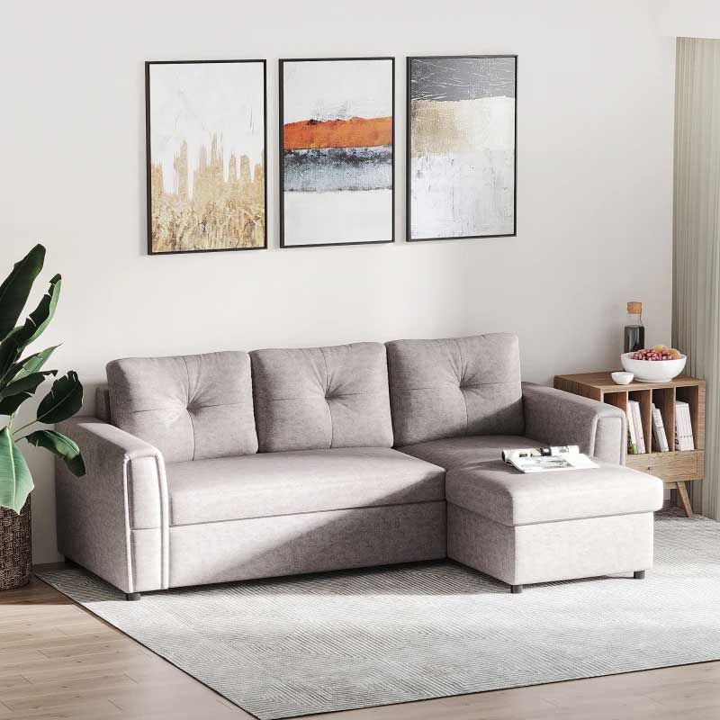 Gray sectional sofa in a living room with wall art and decor.