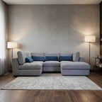 Gray sectional sofa in a living room with a neutral color scheme