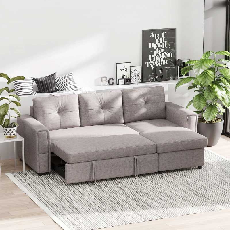 Gray sectional sofa in a living room with plants and decor.