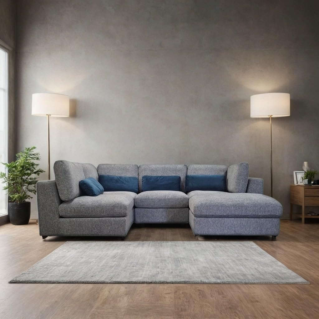 Gray sectional sofa in a living room with two floor lamps and a plant.