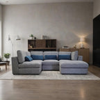 Gray sectional sofa in a modern living room with wooden floor and neutral walls.