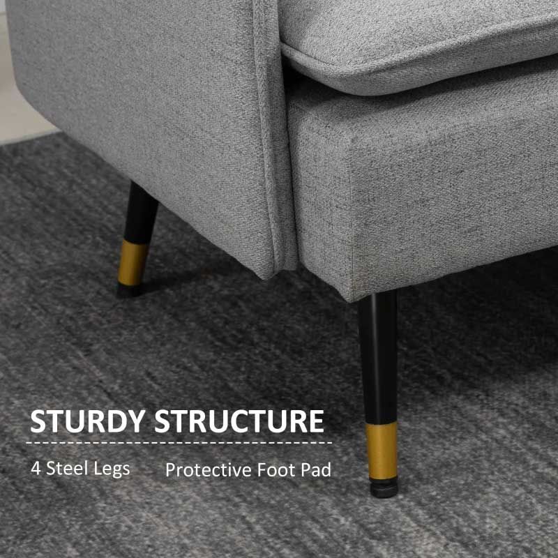 Gray sofa with black and gold legs on a carpeted floor, highlighting sturdy structure.