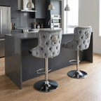 Gray tufted bar stools with decorative buttons in a modern kitchen.