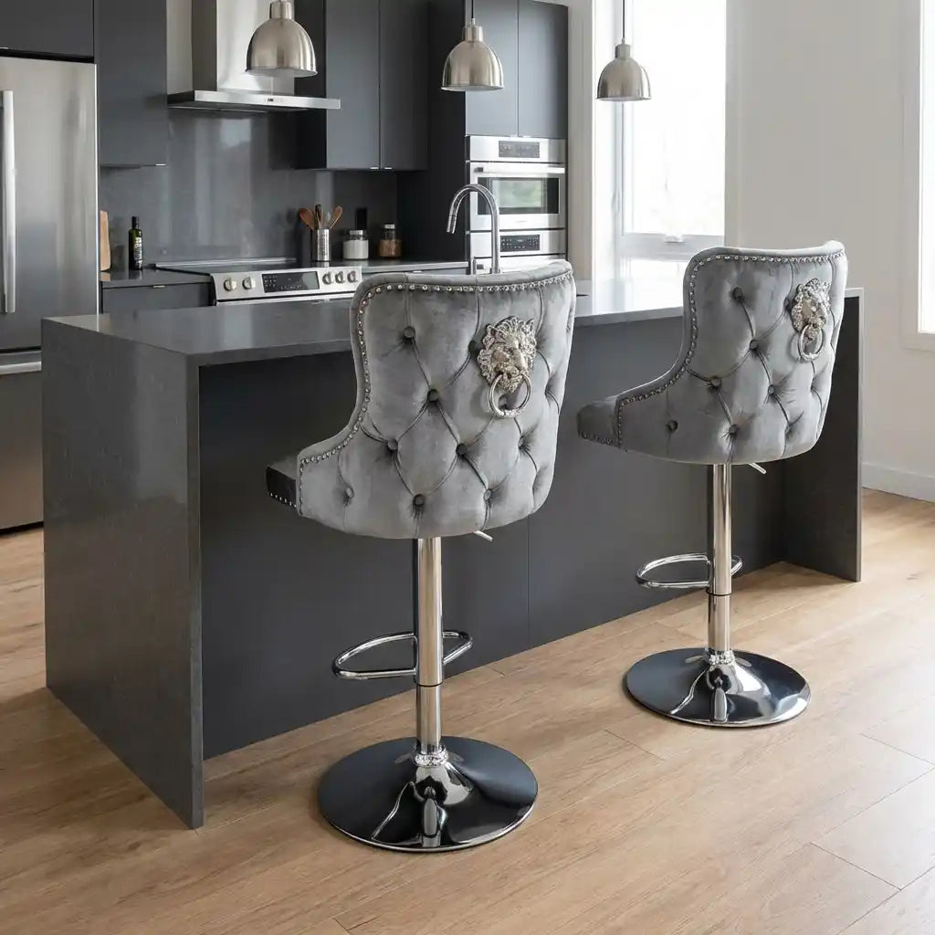 Gray tufted bar stools with decorative buttons in a modern kitchen.