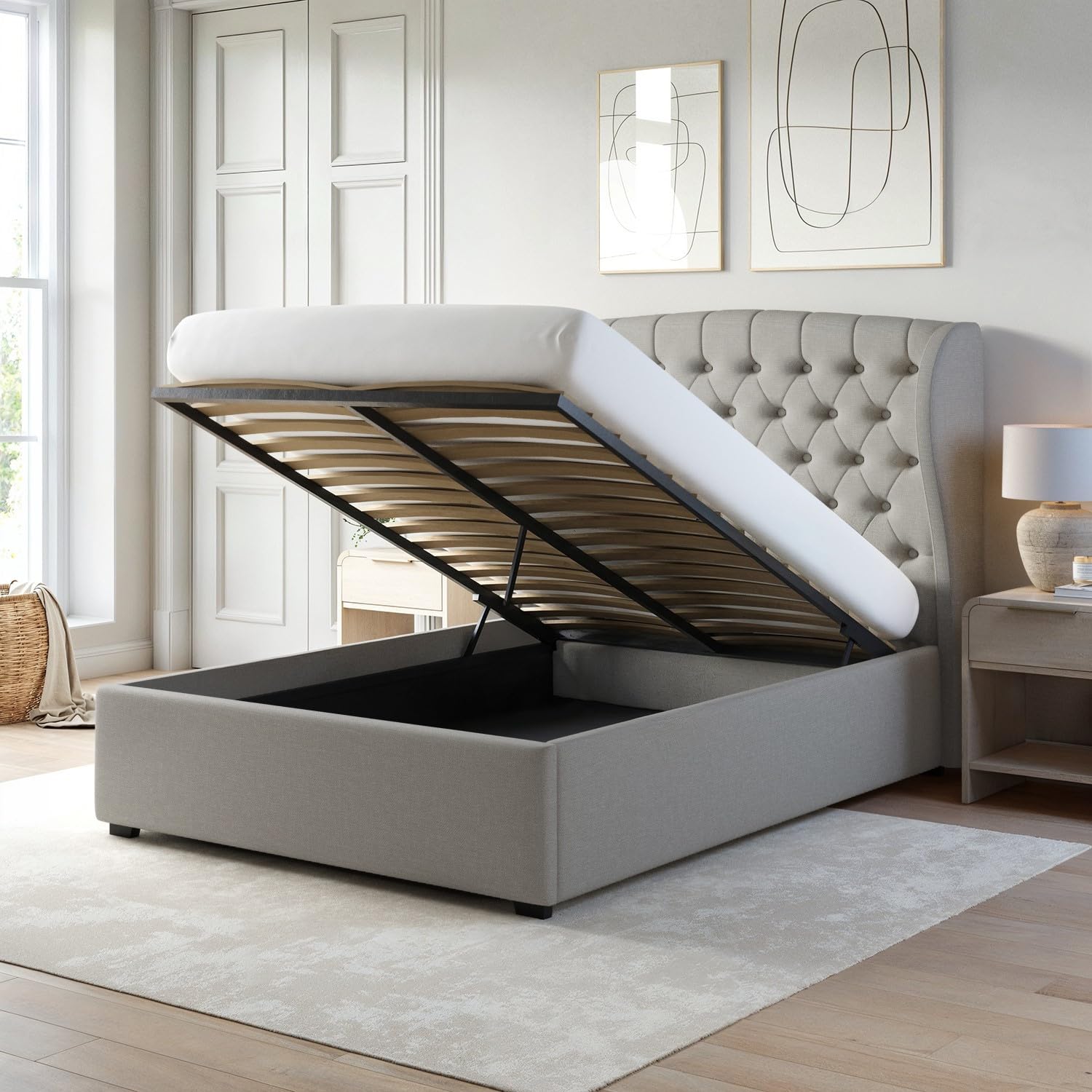Gray upholstered bed with lift-up storage compartment in a bedroom setting.