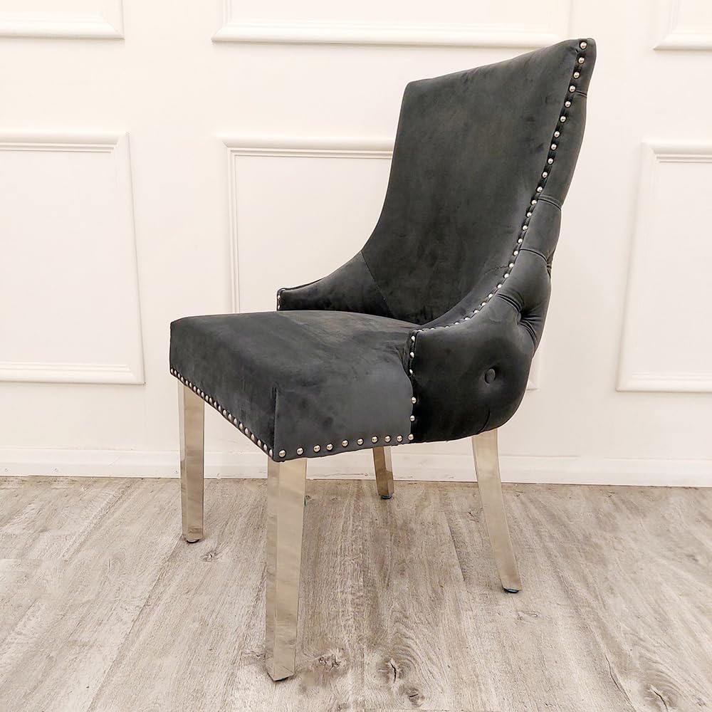 Gray upholstered chair with nailhead trim on a wooden floor.