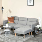 Gray sectional sofabed with a brown pillow in a living room setting.