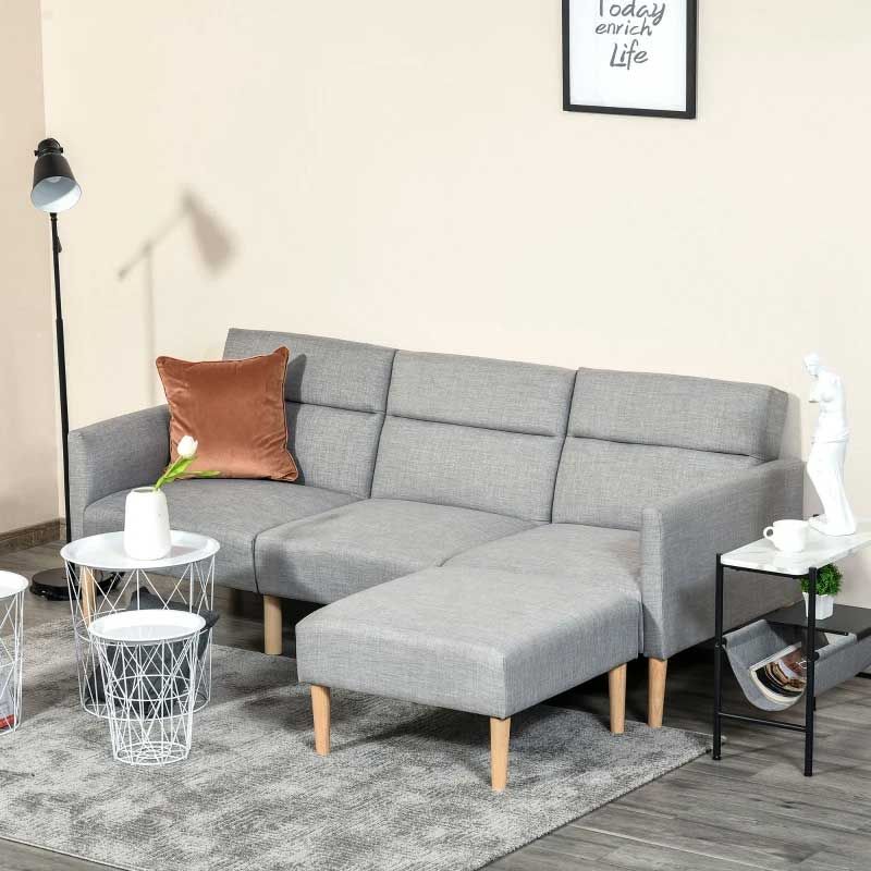 Gray sectional sofabed with a brown pillow in a living room setting.