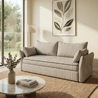Living room with a striped sofa, coffee table, and decorative elements.