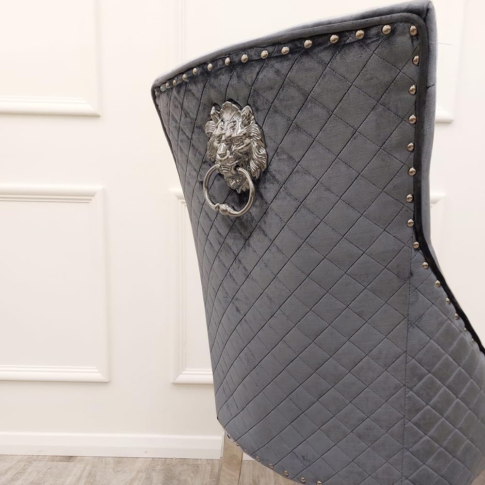 Gray quilted chair with lion head design and studs on a white background