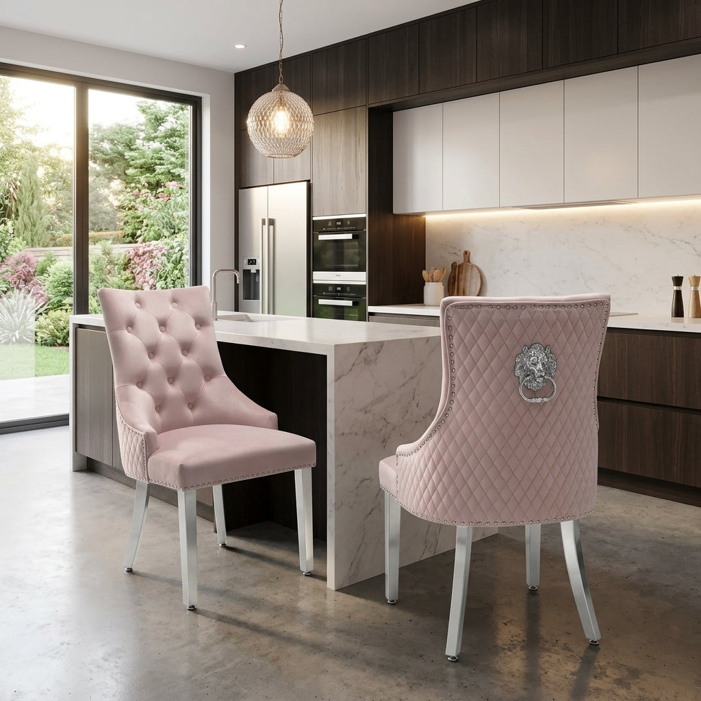 Two pink tufted and quilted dining chairs with silver legs in a modern kitchen setting.