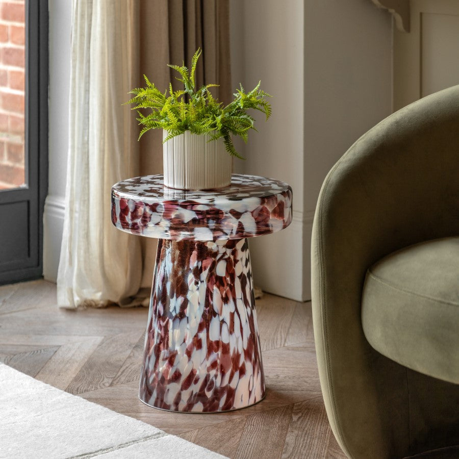 Marbled side table with a plant in a living room setting
