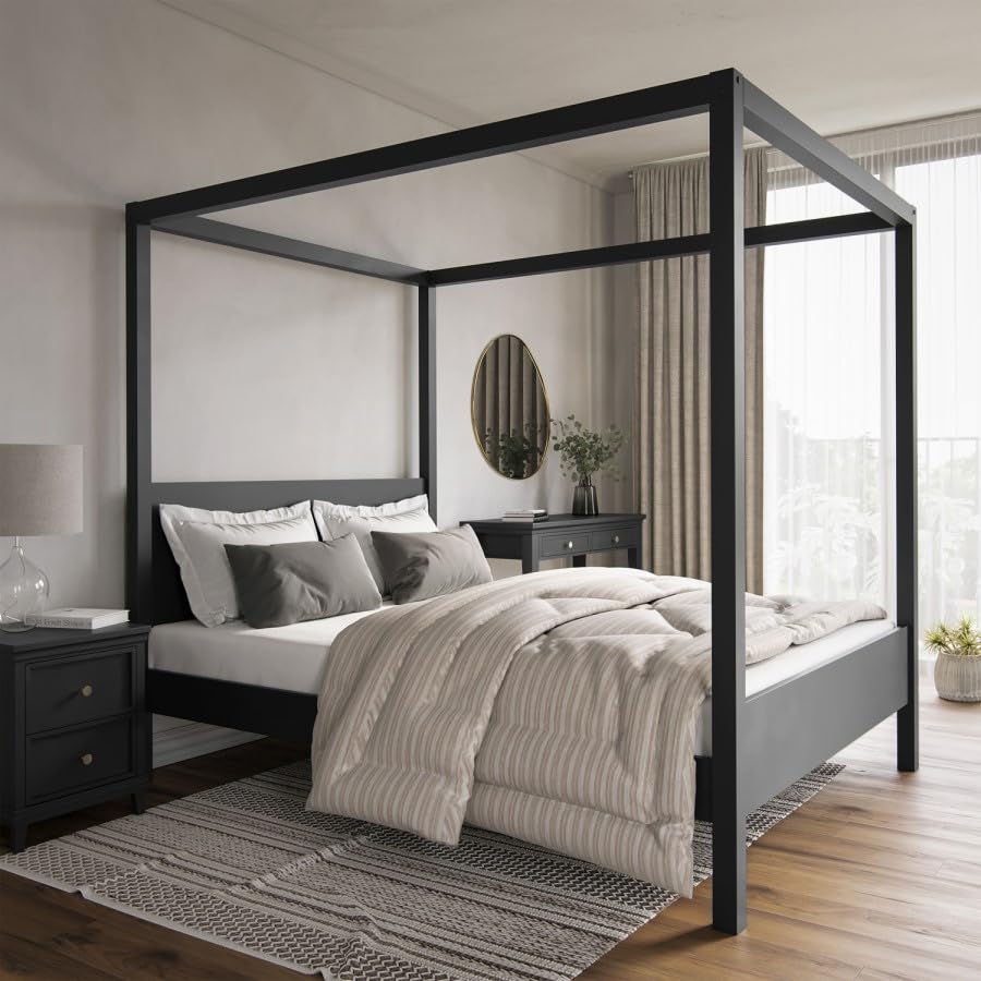 Modern bedroom with a black canopy bed, gray bedding, and wooden flooring.
