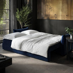 Modern bedroom with a sofabed, side table, and decorative elements.