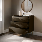 Modern dark brown dresser with open drawer in a room with a round mirror on the wall.