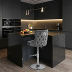 Modern kitchen with dark cabinets, a island, and a gray bar stool.