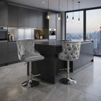 Modern kitchen with gray bar stools and a cityscape view.