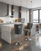 Modern kitchen with gray island chairs and marble countertops