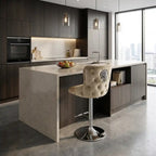 Modern kitchen with island and bar stool, featuring dark wood cabinets and a large window.