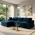 Modern living room with a blue sectional sofa, abstract painting, and decorative items.