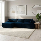 Modern living room with a dark blue sectional sofa, light gray walls, and decorative elements.